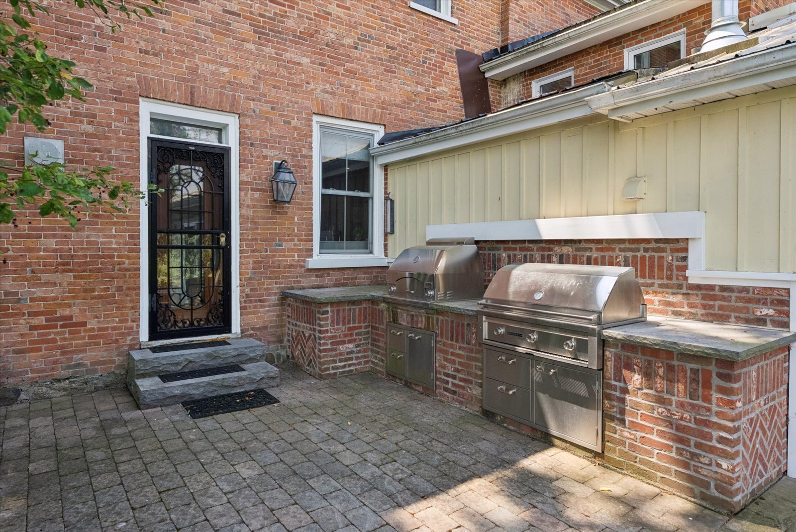 Courtyard with built-in brick outdoor kitchen