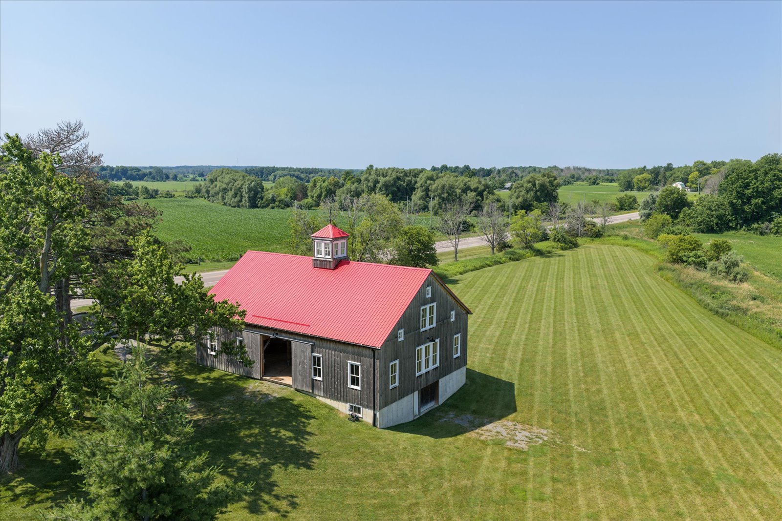 Aerial of the barn's red roof and cupola from the east