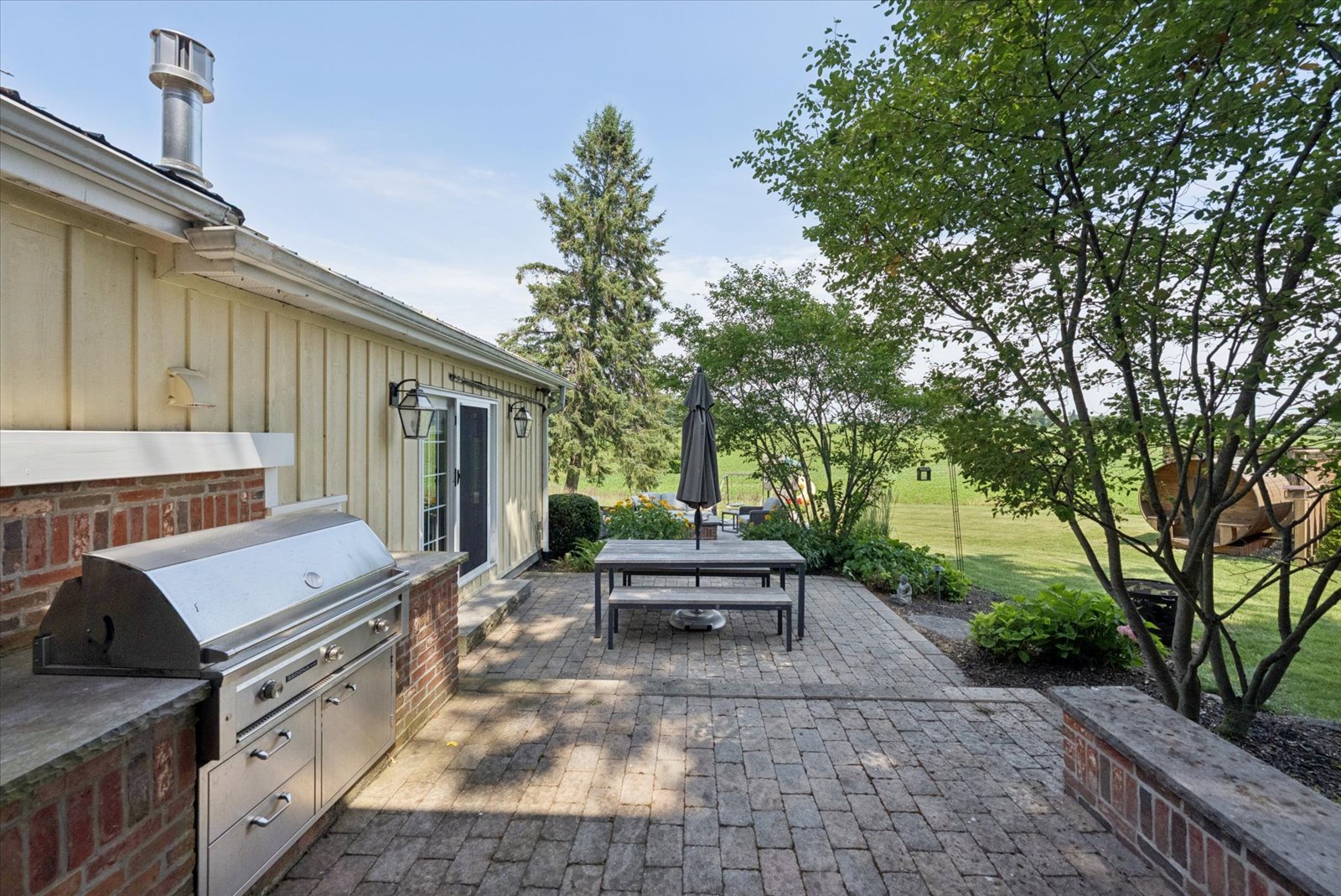 Paver terrace with dining table and grills