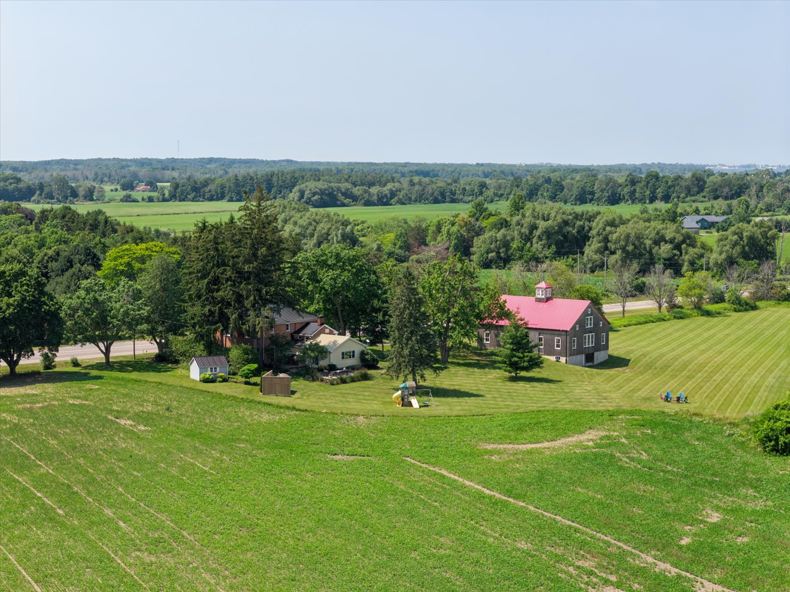 Barn, house and outbuildings above the rolling farmland