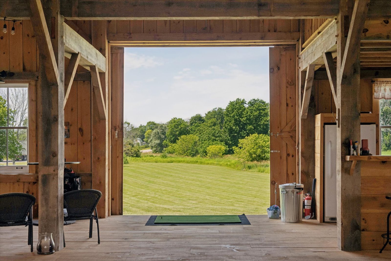 Open barn doors looking out over the mown field