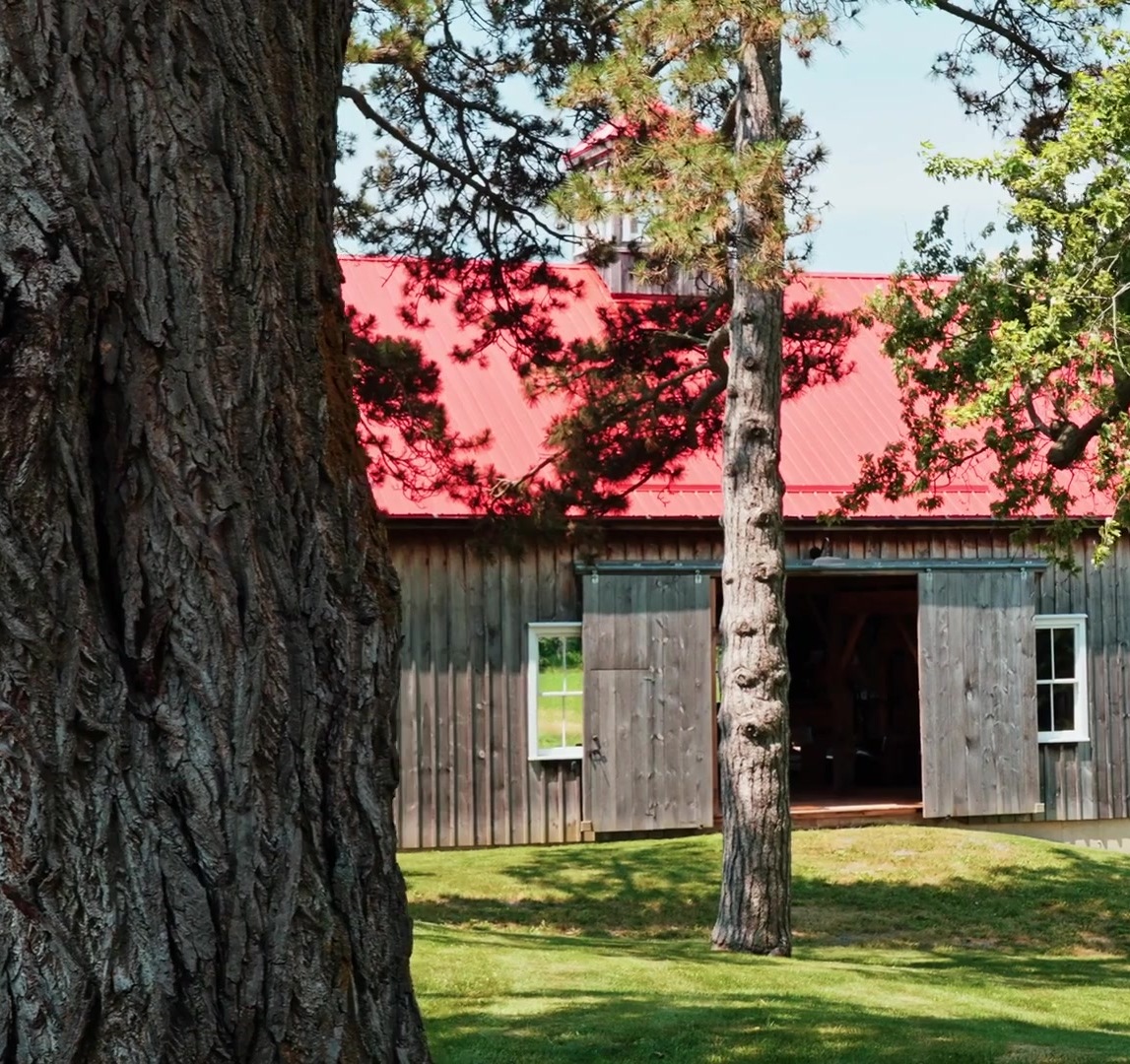 The Dutch-style barn with red metal roof