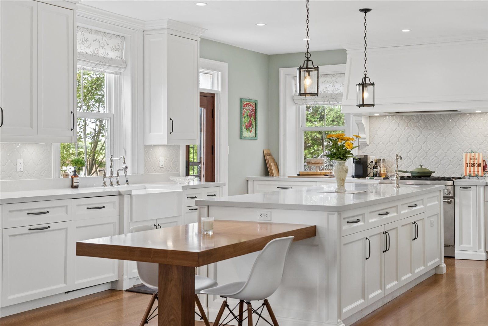 Chef's kitchen with farmhouse sink and arabesque tile backsplash